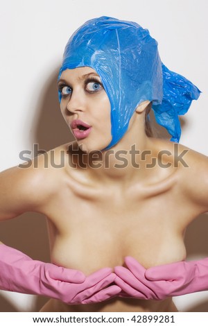 stock photo Bizarre naked woman in pink gloves and blue cap over white