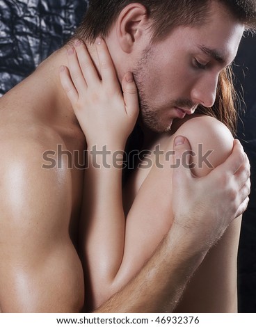 stock photo Naked young couple kissing and embracing