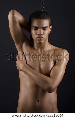 stock photo Drops of the water on naked body of a young man on black