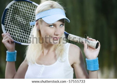 Female tennis player with a racket outdoors