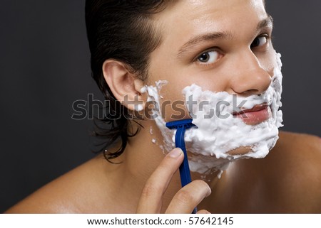Sexy handsome young man shaving
