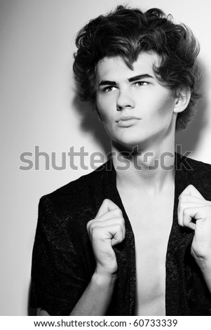 Portrait of male fashion model with stylish hairstyle and makeup