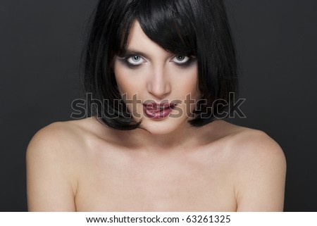 Portrait of a cute young brunette licking her lips and making face