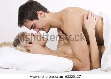 stock photo Loving affectionate nude heterosexual couple on bed in 