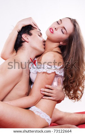  stock photo Young sexy heterosexual couple making love in bed