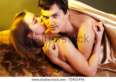 Young sexy heterosexual couple making love in bed