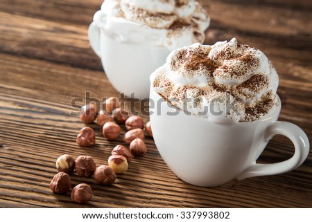 Cup Of Cappuccino With Whipeed Cream Over Wooden Table