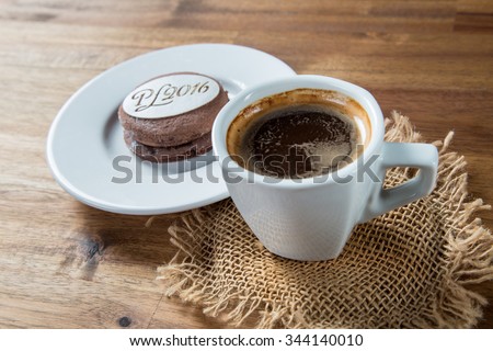 New Year's sweet with coffee on brown wooden background. New Year 2016 in shape of sweets. Design element for, New year's day, Christmas, sweet-stuff, winter holiday, new year's eve, food, etc