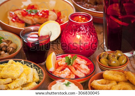 A table filled with all sorts of Spanish tapas and sangria.