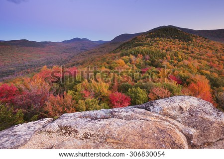 Endless forests with fall foliage in the White Mountain National Forest, New Hampshire, USA. Photographed from North Sugarloaf at dusk.