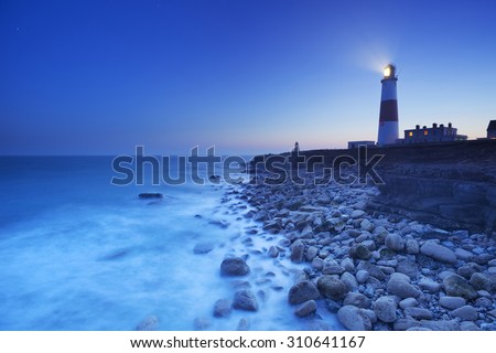 The Portland Bill Lighthouse on the Isle of Portland in Dorset, England at night.