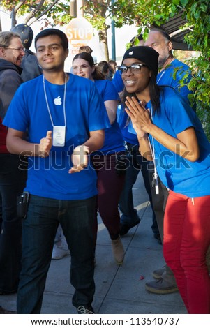 BERKELEY, CA-SEPT 21: Apple employees applaud line of customers waiting to buy the new iPhone 5 at the Apple store in Berkeley, CA on Sept. 21, 2012. Some camped overnight to stake out a spot in line.