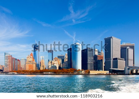New York City skyline and waterfront viewed from the water facing lower Manhattan. Wide angle view includes the new World Trade Center under construction.