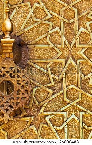 Detail of the brass door and knocker at the royal palace in Fez, Morocco. Islamic design and pattern.