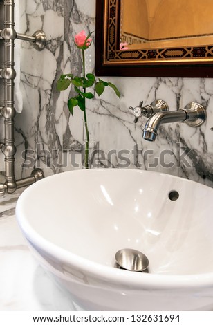 Sink in a white marble bathroom