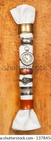 Vintage napkin rings displayed on a rustic wooden background. Close up detail and texture. Top view, looking down.