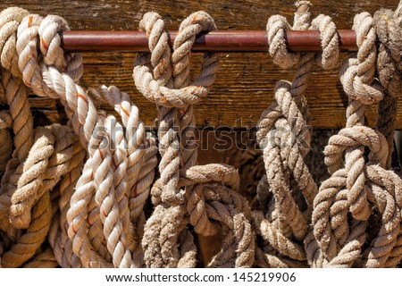 Nautical ropes on a tall ship. Close up detail of knots and texture.
