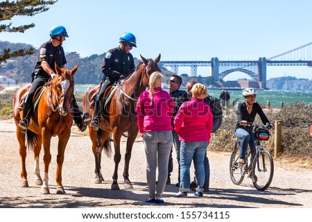 SAN FRANCISCO-SEPT 25: US Park Police officers greet visitors on Sept. 25, 2013 in San Francisco. The federal horse-mounted patrol operates only in parks in Washington DC, New York and San Francisco.