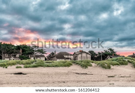 Beachfront living along the Oregon coast. Vivid sunrise colors and clouds. Location: Cannon Beach, Oregon, USA