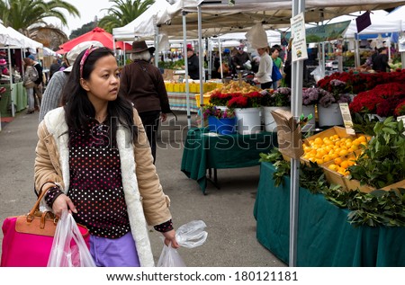OAKLAND, CA-JAN. 11, 2014:Shoppers at the Grand Lake Farmers Market, one of the largest in the region. More than 100 farmers participate. bringing fresh produce to the urban city center.