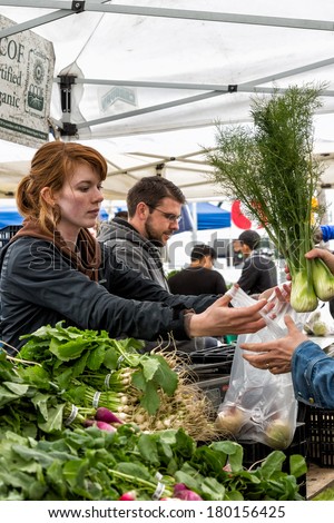 OAKLAND, CA - JAN. 11, 2014: Certified Organic farmers sell their fresh produce at the Grand Lake Farmers Market, one of the largest in the region. More than 100 vendors participate.