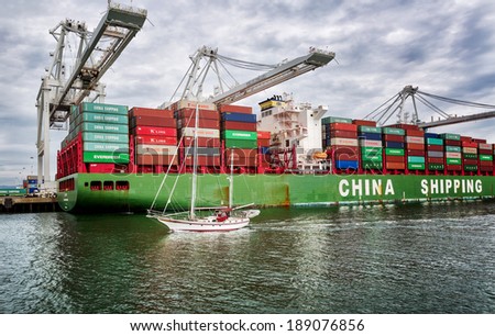 OAKLAND, CA-MAR 9, 2014: A loaded cargo ship at the Port of Oakland in Oakland, California.The fourth busiest container port in the country, it's a major economic engine in the San Francisco Bay Area.