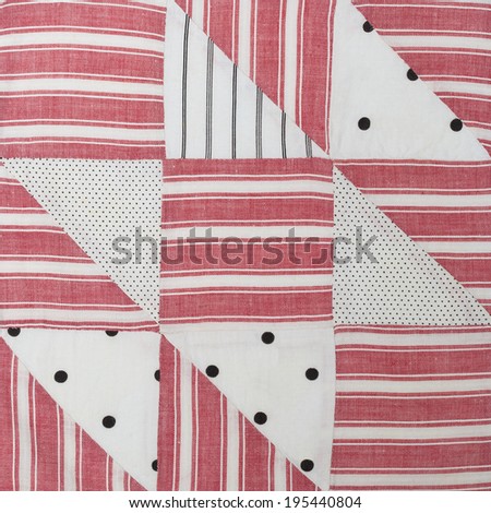 Vintage quilt square stitched by hand. Red, white, black colors with stripes and dots.