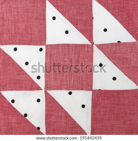 Vintage quilt square stitched by hand. Red, white, black dots
