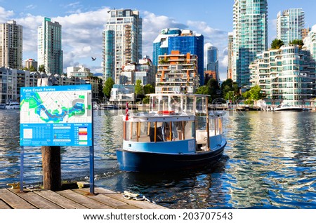 VANCOUVER-JUN 29, 2014: Little ferry boats carry passengers up and down False Creek Inlet, making stops at docks like this one on Granville Island. They are popular with both tourists and locals.