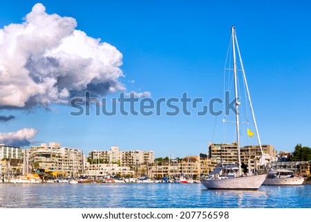 Vancouver Canada marina and waterfront with blue sky and a dramatic cloud overhead. Copy space.