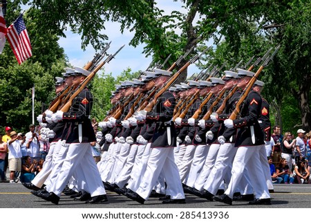 WASHINGTON DC-May 25, 2015: Memorial Day Parade. A marching platoon from the United States Marine Corps wearing blue-white dress uniforms. Close up profile view.