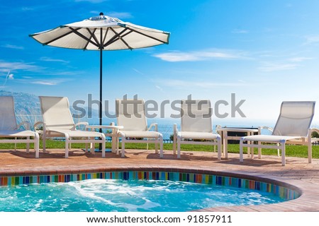 Outdoor spa pool with view of California ocean on a sunny day with blue sky