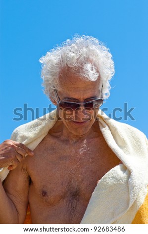 Active senior man drying off after a swim