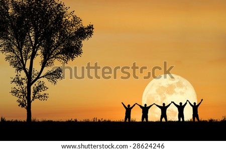 A scenic view of people raising their hands with the full moon in the background