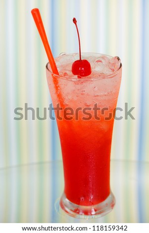 Colorful ice drink with cherry on top