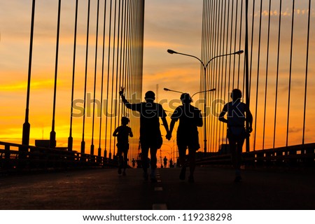 Marathon runner running on bridge in the morning