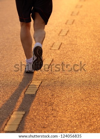 Runner running in the light of evening