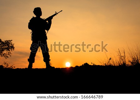 Silhouette shot of soldier holding gun