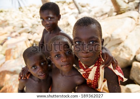 TAKORADI, GHANA - MARCH 22: Unidentified african boys from native fishing village greeting to tourists on May 22, 2014 in Takoradi, Ghana. Takoradi has many fishing village and beautiful beach.