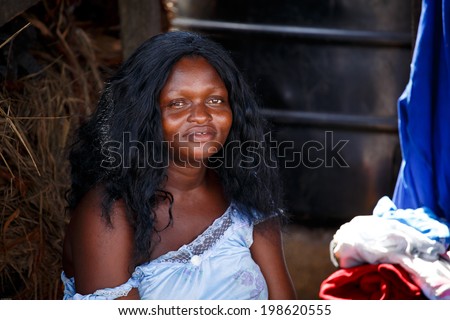 ACCRA, GHANA - MARCH 18: Unidentified african woman pose and look at camera on March 18, 2014 in Teshie community, Accra, Ghana. Ghana is one of the most tourists destination in Africa.