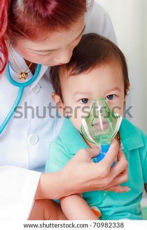 Doctor putting medical mask on baby's face