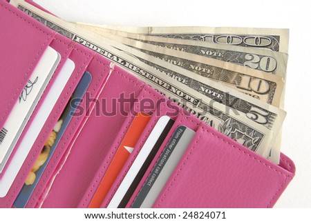 Hot Pink wallet is filled with credit cards and lots of cash, on a white background.