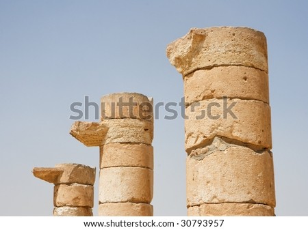 Three broken column tops of ancient temple