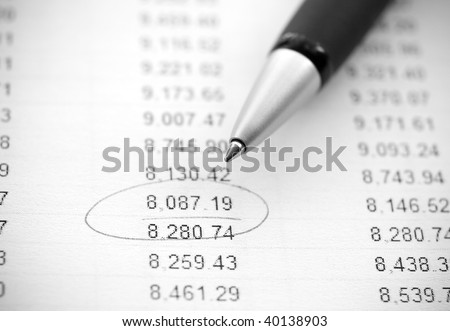 Business still-life: financial report and pen