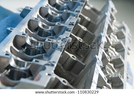 The block of cylinders from the engine of a sports car on a workshop table