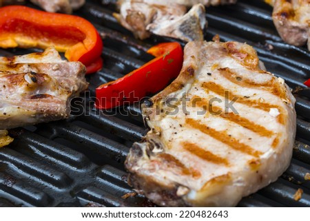 Meat and sweet paprika on a gas grill
