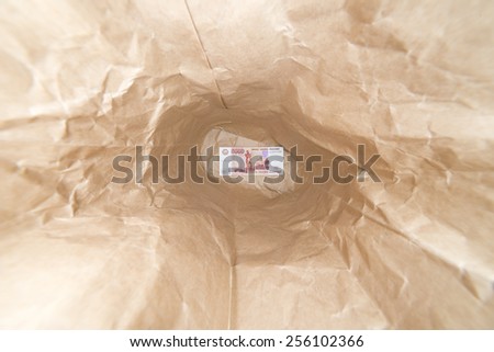Money inside the crumpled paper bag. One banknote of five thousand rubles.