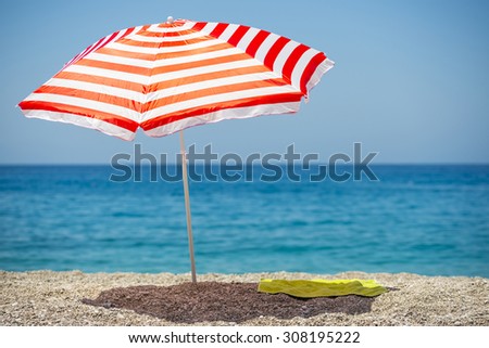 Striped beach umbrella on the beach.