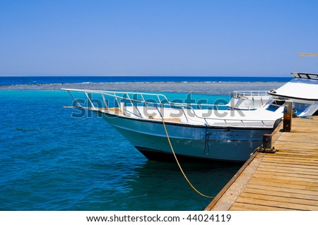 White yacht moored by the pier in the Red sea, Egypt