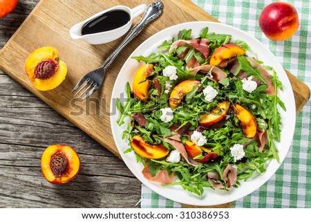 peaches, arugula, prosciutto and goat cheese salad with balsamic vinegar